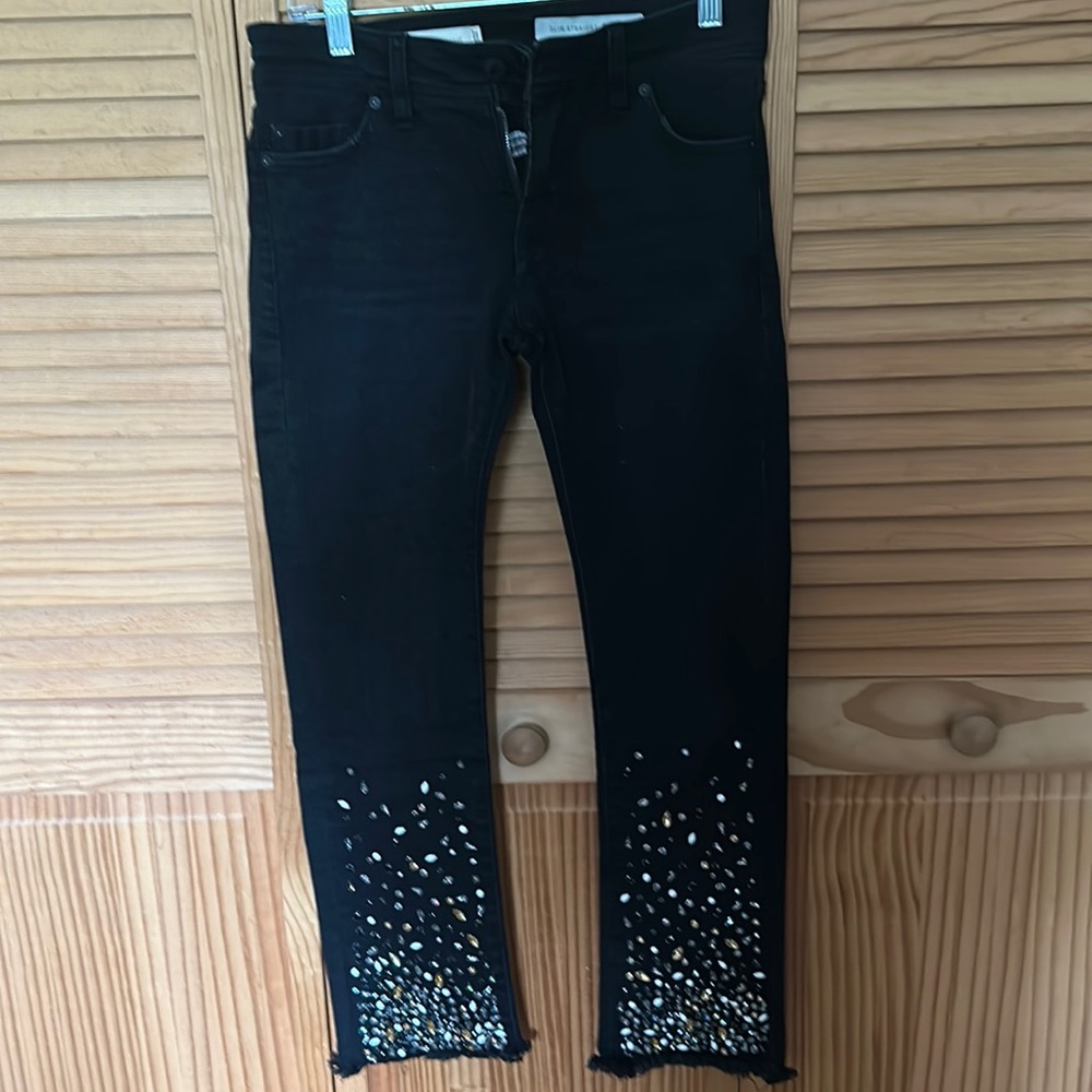 Black frayed hem jeans with bead detail.